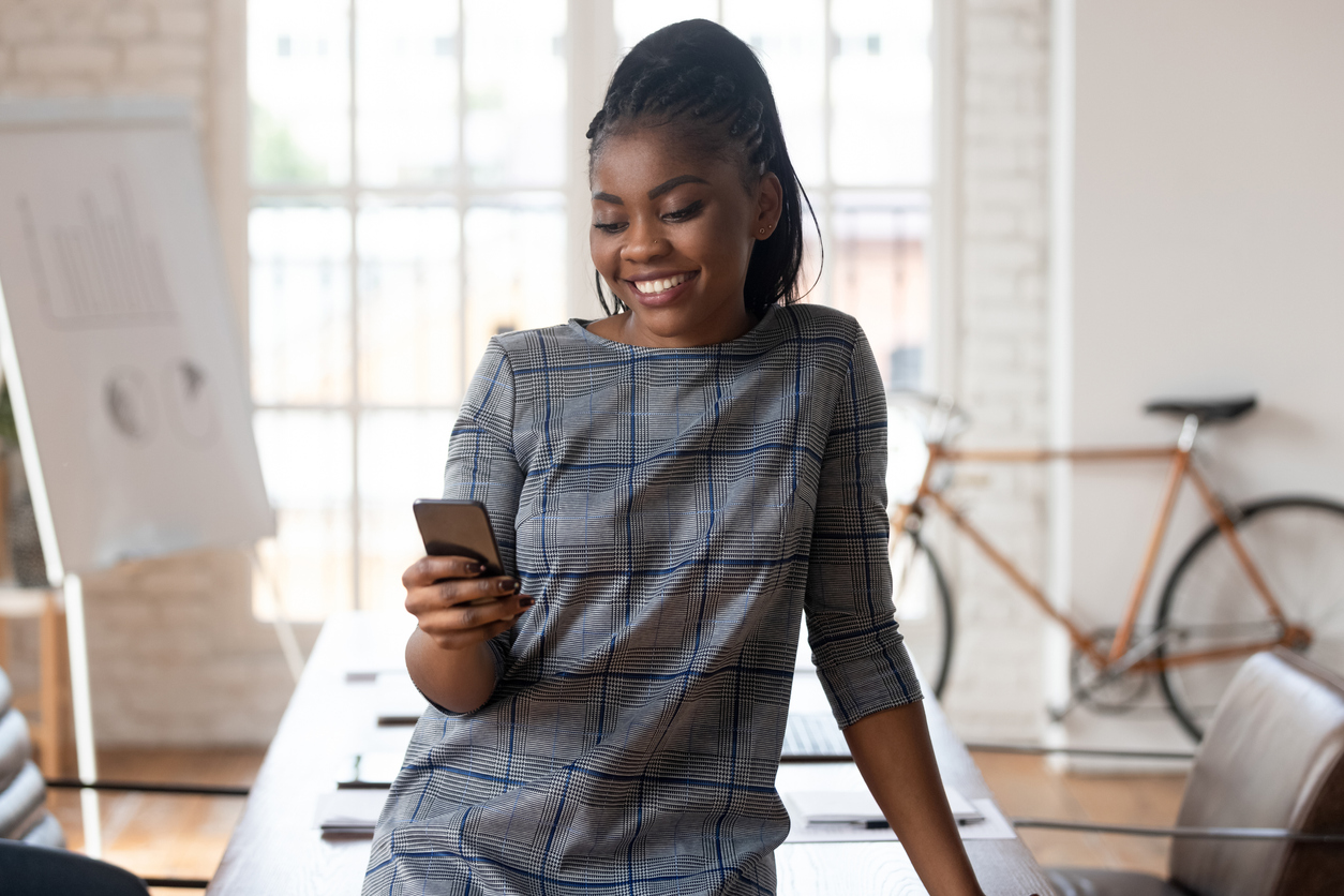 A businesswoman using social media on a mobile phone