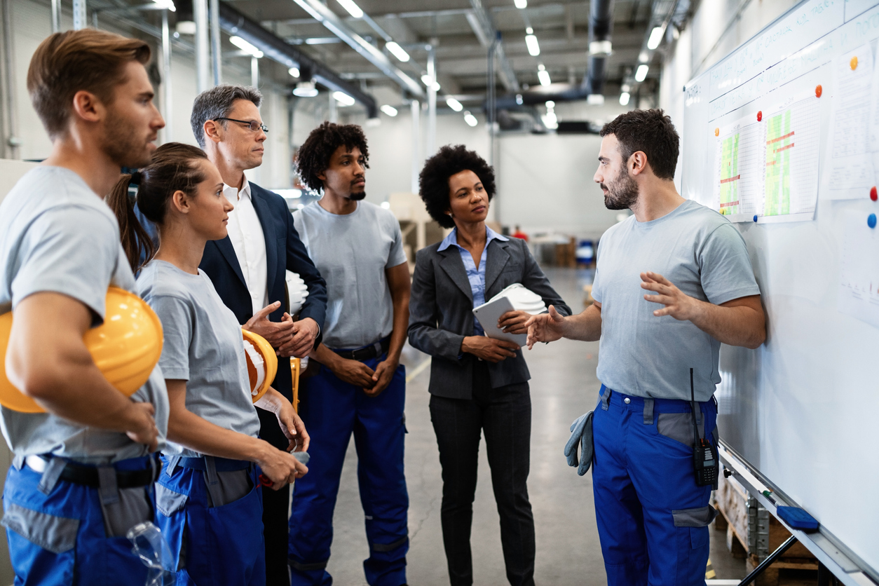 Young worker giving presentation to his boss and co-workers