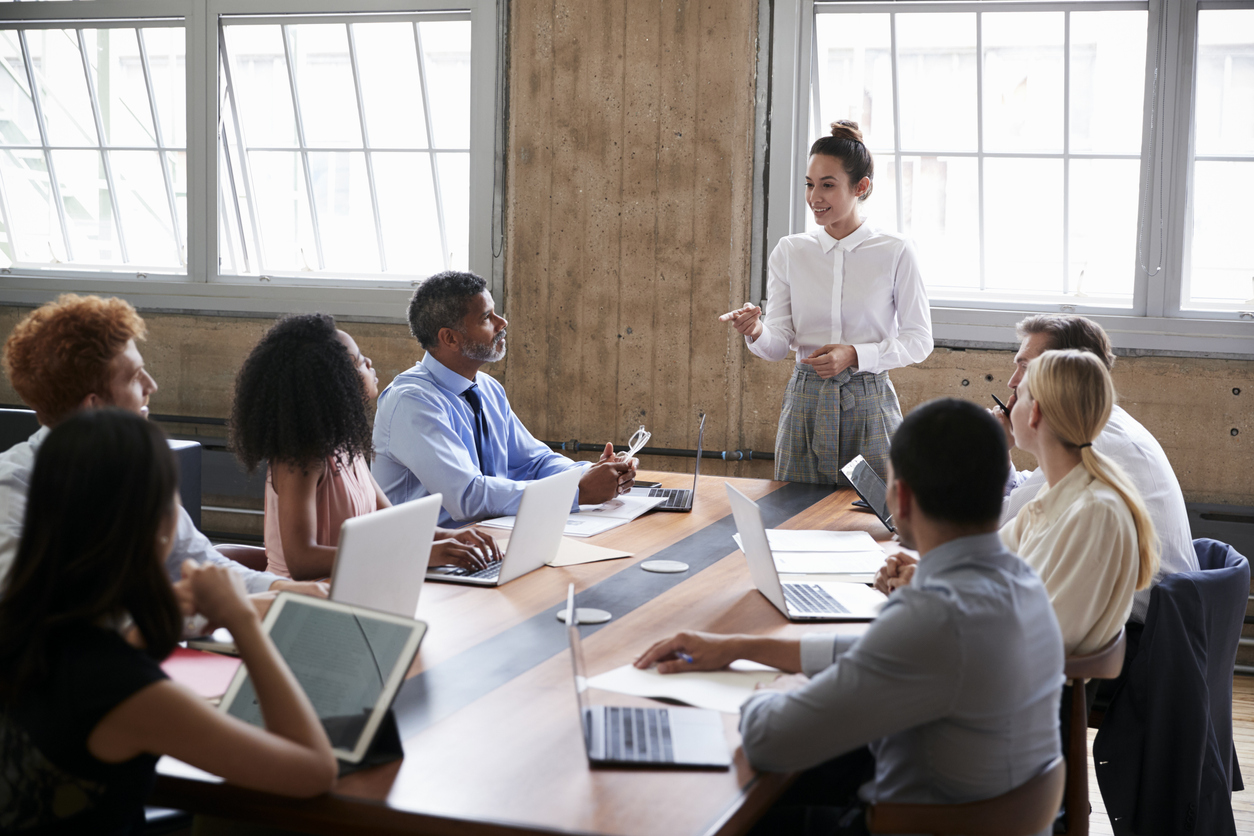 Female manager addressing team at a board meeting