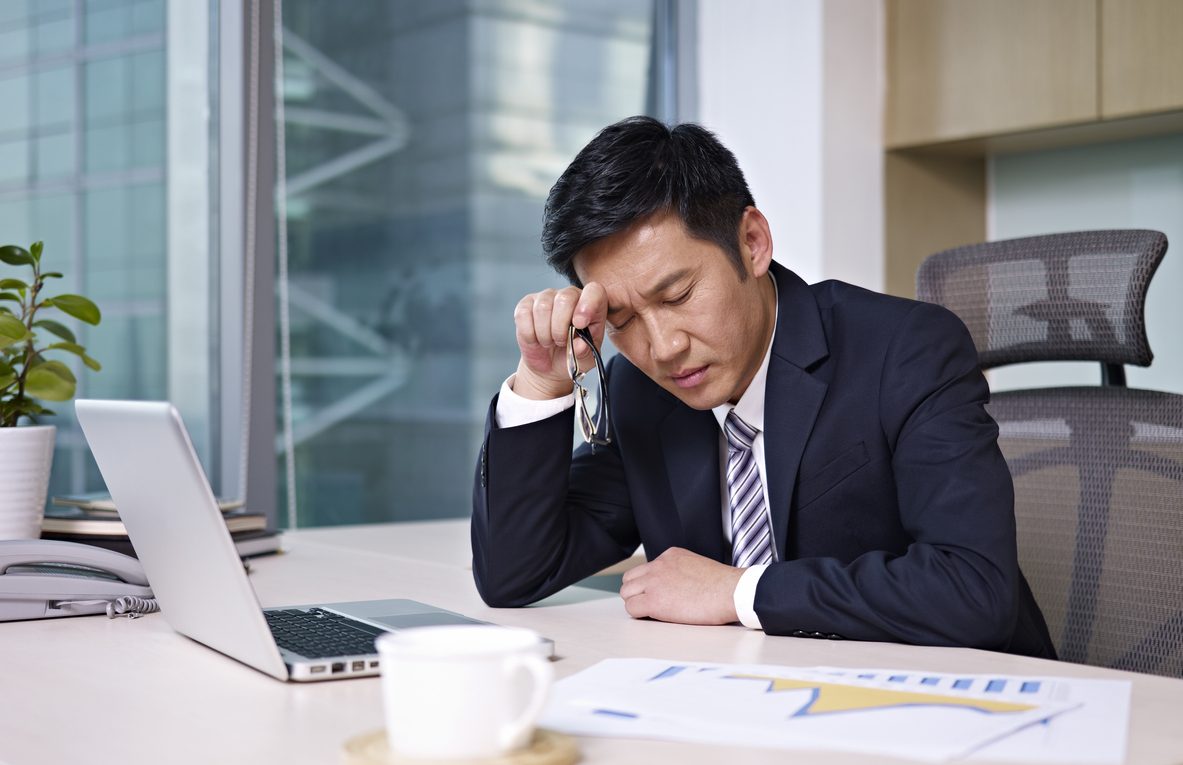 Stressed executive using a laptop