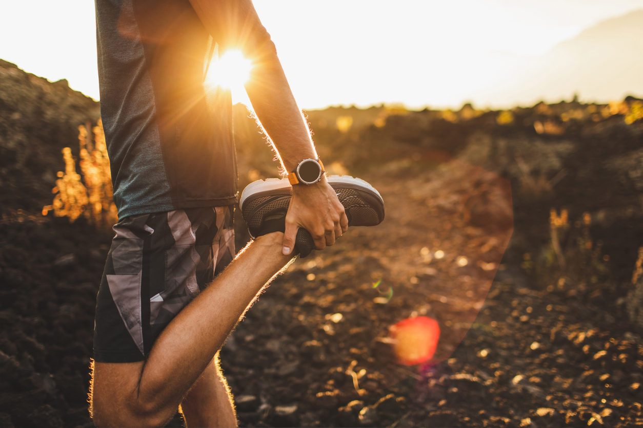 Male runner stretching outdoors