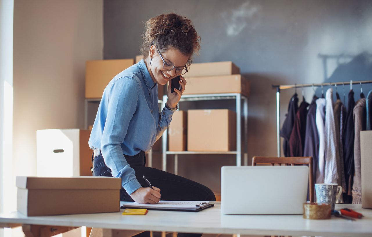 Young e-commerce business entrepreneur on phone