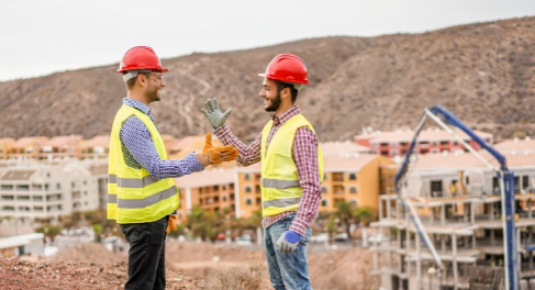 Two construction workers high-fiving