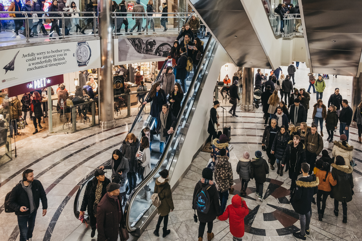 People in shopping centre, London, UK.