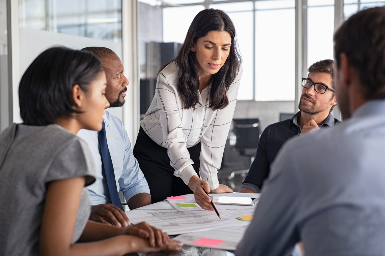 Female business leader pointing to notes