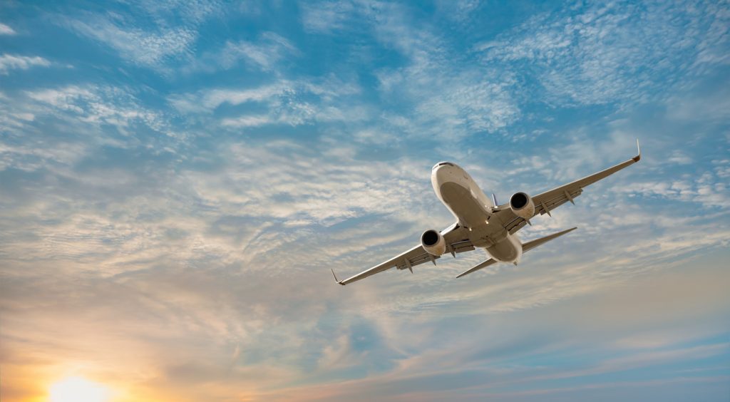 Airplane flying over tropical sea at sunset - Antalya, Turkey