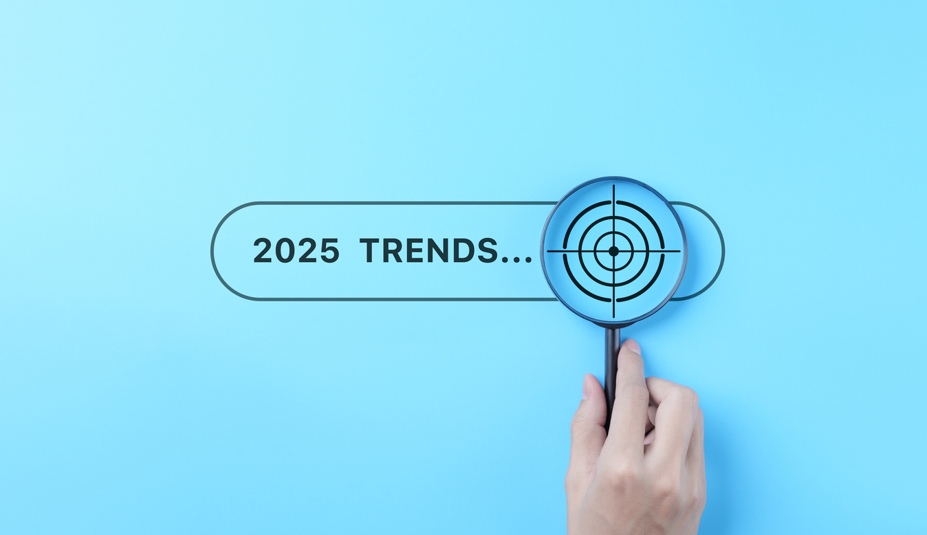 trends 2025 year concept. hand holding magnifying glass with 2025 trend searching bar for optimization 2025 business marketing trends and business plan in new year. find information and new ideas.