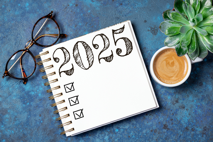 new year resolutions 2025 on desk. 2025 resolutions list with notebook, coffee cup on table. goals, resolutions, plan, action, checklist concept. new year 2025 template