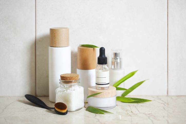 face cream, serum, lotion, moisturizer and sea salt among bamboo leaves