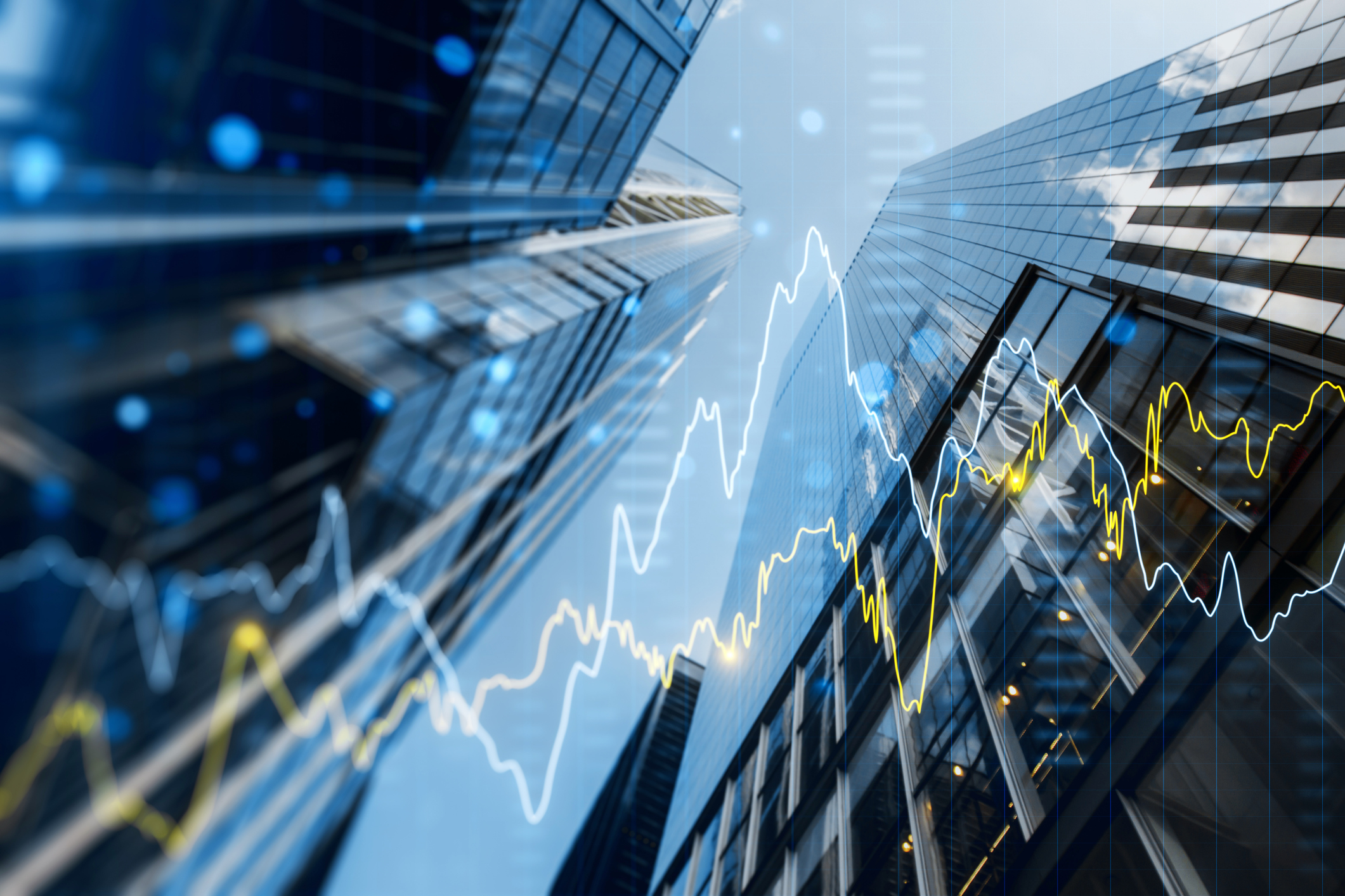 a double exposure image of skyscrapers with overlay of financial graphs, set against a blurred background, illustrating the concept of business growth