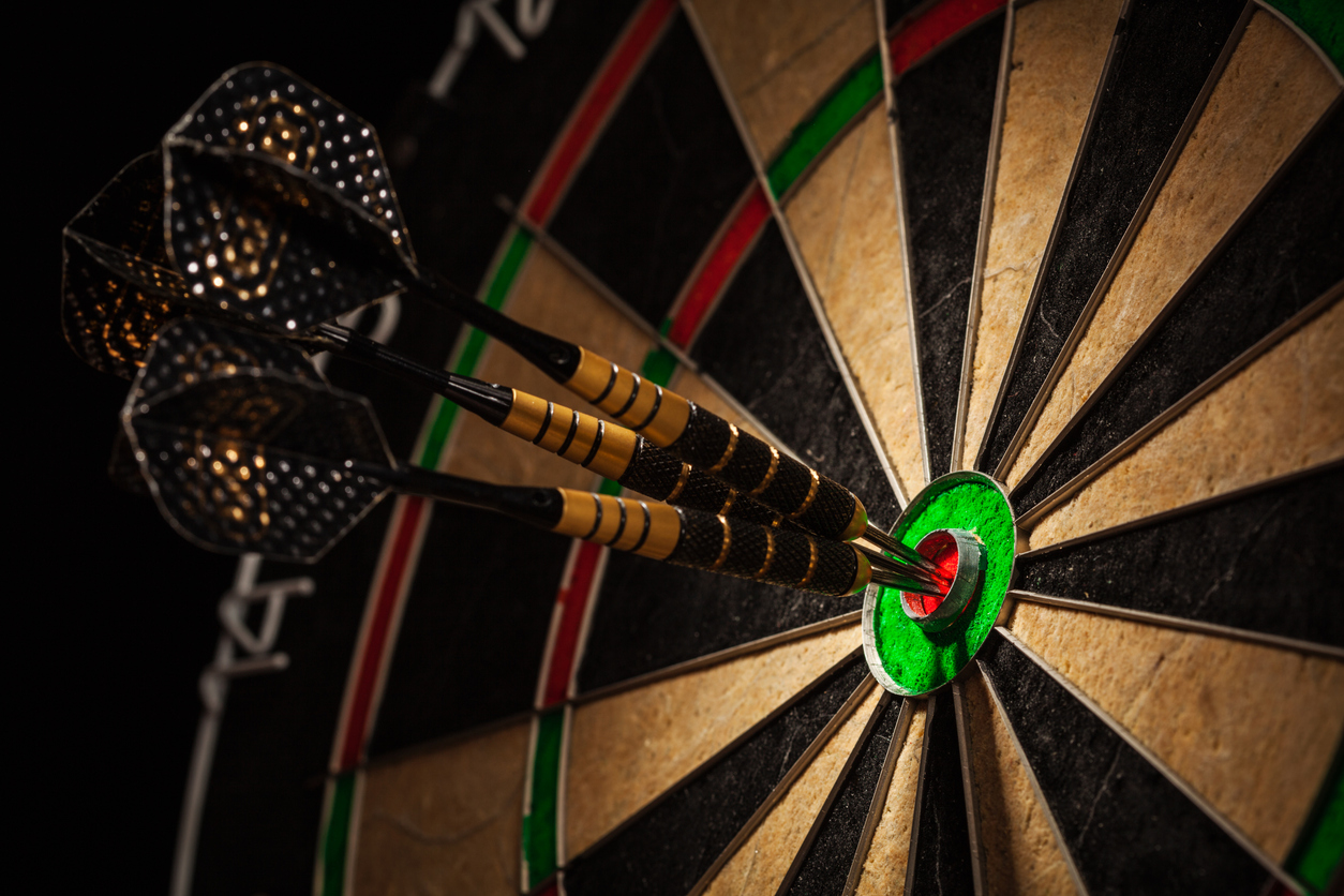 three darts in bull's eye close up