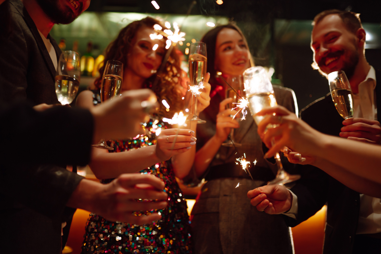 sparkling sparklers in the hands. playing firework to celebrate winter holidays with friends at the party.