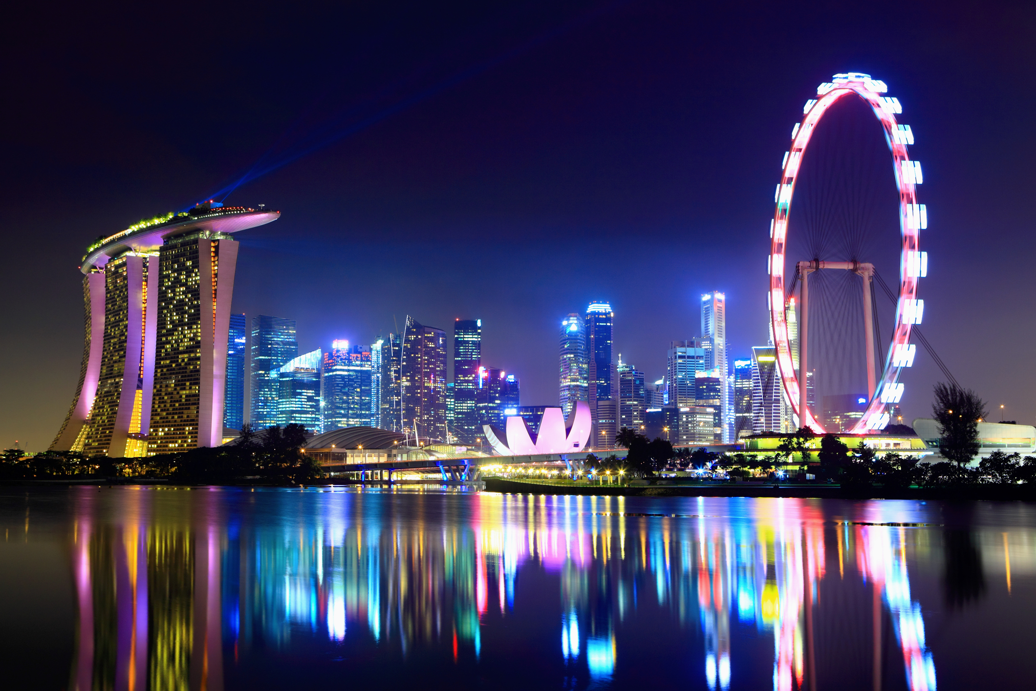 lake reflecting the singapore city skyline at night