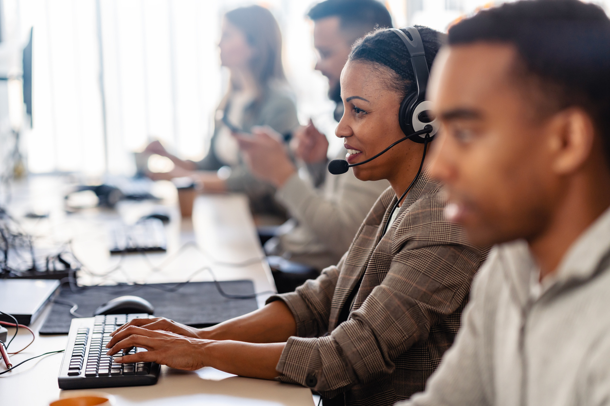 multiethnic group of it profesionals working togeter using computers in their office