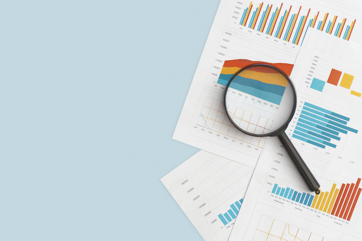 business graphs, charts and magnifying glass on table. financial development, banking account, statistics